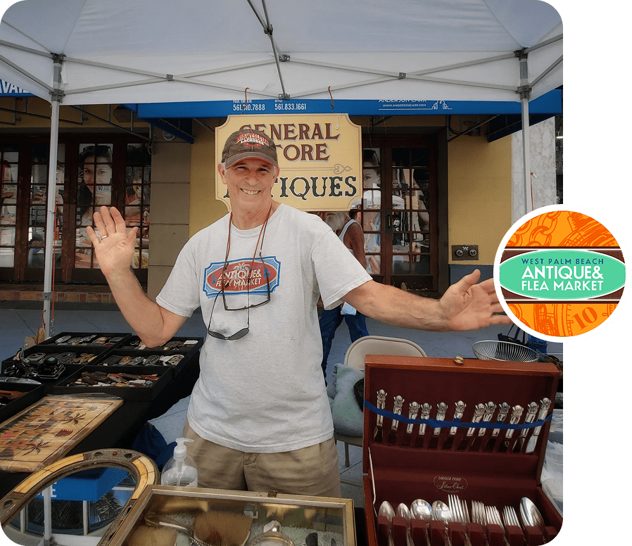 Smiling antique vendor waving at flea market