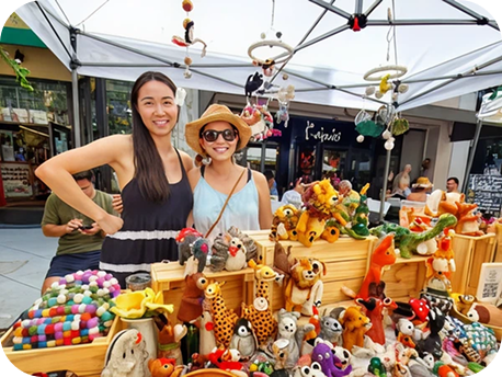 Two women at outdoor plush toy stall