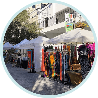Outdoor street market with colorful clothing racks