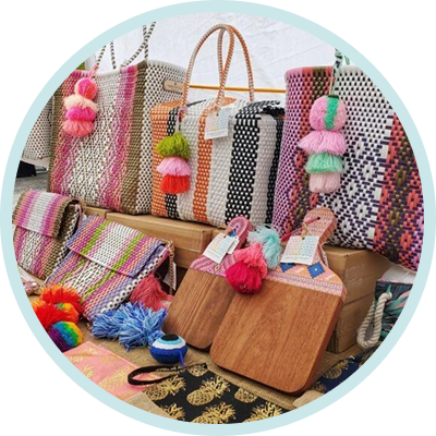 Colorful woven market bags with pom-poms